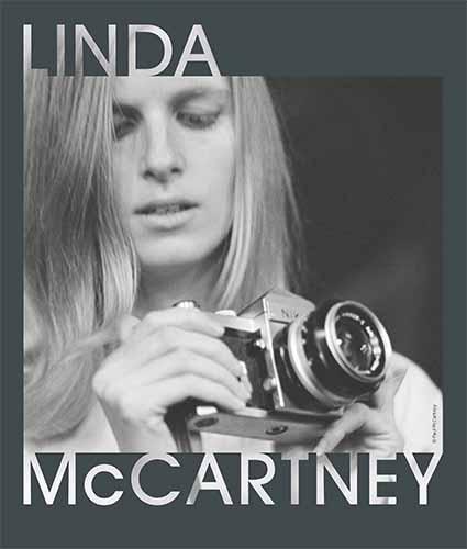 Linda McCartney holding a camera with her name over the image