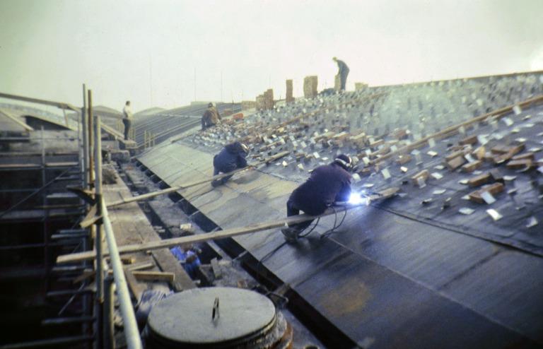 Photograph of renovation of Albert Dock, Liverpool, Block D, later Merseyside Maritime Museum, roof to north side showing pop riveting of stainless steel cleats to receive cork roof insulation. card