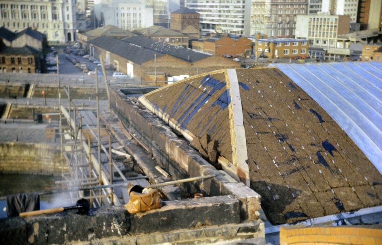 Photograph of renovation of Albert Dock, Liverpool, Block D, later Merseyside Maritime Museum, north east corner of roof.  Cork insulation on hipped end with lead coated stainless steel roof sheets to the rest.  Build up of finishes. card