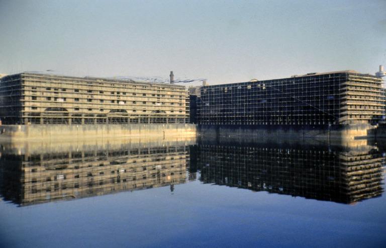 Photograph of renovation of Albert Dock, Liverpool, Block D, later Merseyside Maritime Museum and Block E.  View looking north to Block D, south elevation and Block E, west elevation, both scaffolded, from across Albert Dock. card