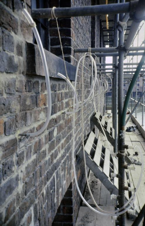 Photograph of renovation of Albert Dock, Liverpool, Block D, later Merseyside Maritime Museum, west elevation, resin injecting external walls. card