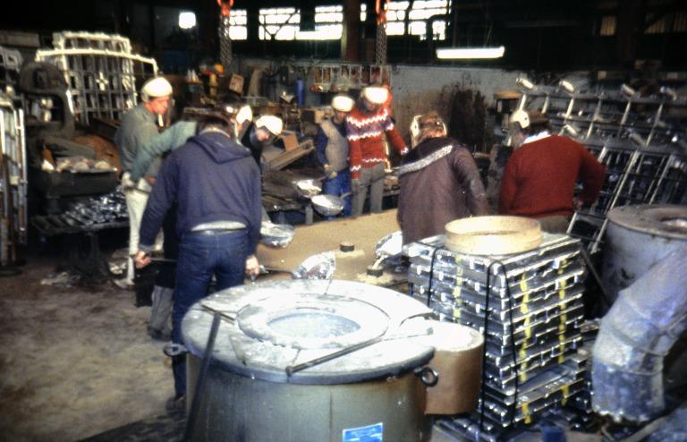 Photograph relating to renovation of Albert Dock, Liverpool, Block D, later Merseyside Maritime Museum of Keighley Foundry, Yorkshire, pouring molten aluminium into the sand mould for casting replica windows for Block D. card