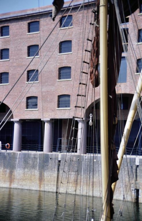 Photograph of renovation of Albert Dock, Liverpool, Block D, Merseyside Maritime Museum, section of near completed south elevation from Block E across Albert Dock. card