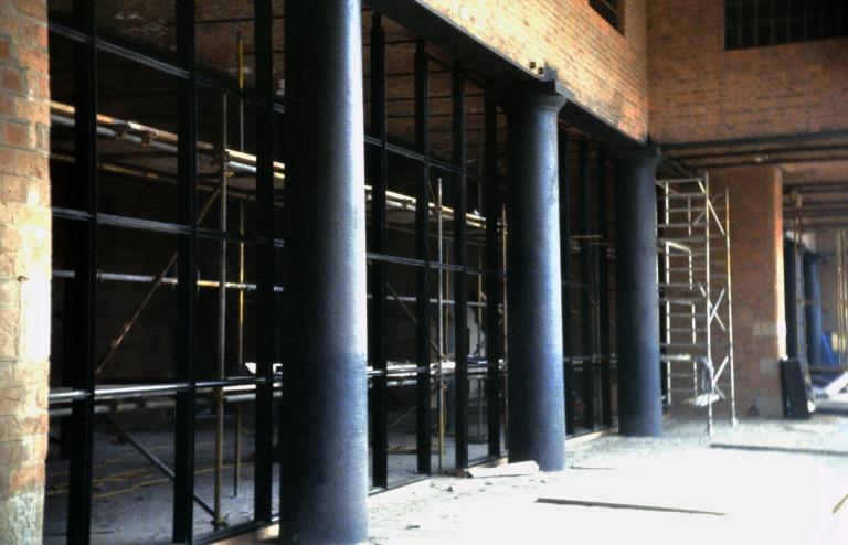 Photograph of renovation of Albert Dock, Liverpool, Block D, Merseyside Maritime Museum, section of south elevation from colonnade, large glazed window screen being installed. card
