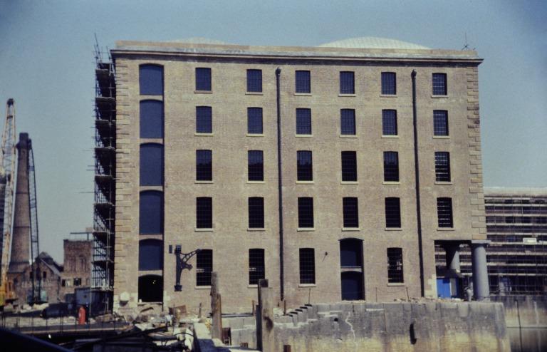 Photograph of renovation of Albert Dock, Liverpool, Block D, later Merseyside Maritime Museum, west elevation with North elevation still scaffolded, Pump House and partial view of Block E, west elevation, still scaffolded. card