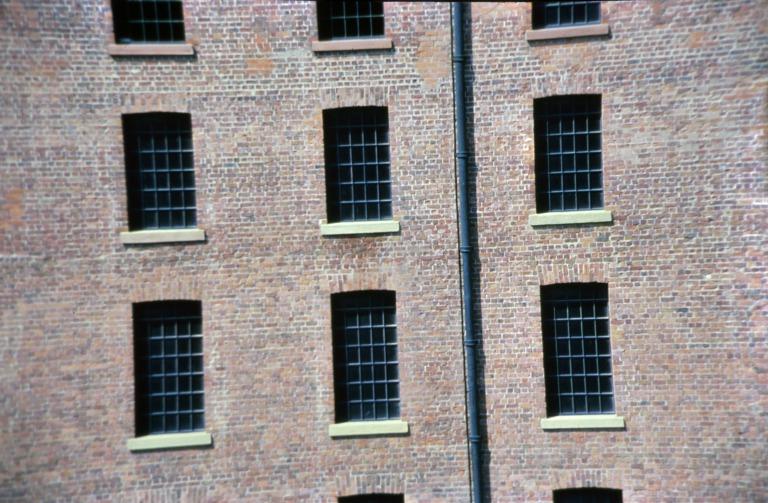 Photograph of renovation of Albert Dock, Liverpool, Block D, Merseyside Maritime Museum, west elevation with new aluminium windows, sandstone sills and restored brickwork.  Likely to be viewed from Block C. card