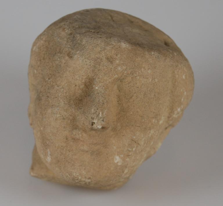 Head from a votive statuette card