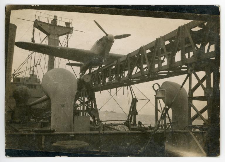 Photograph of a Hurricane fighter plane in a catapult on the deck of the MV Daghestan, Hindustan Steam Shipping Co. Ltd. card
